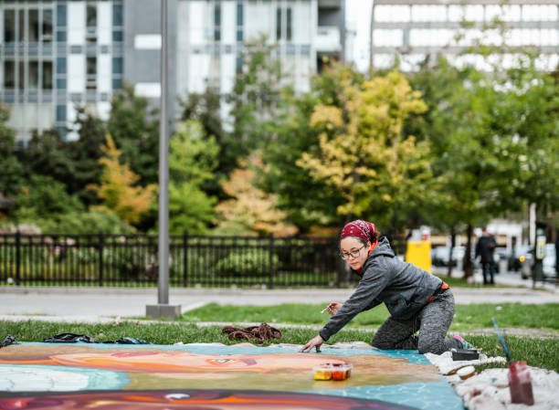 istock Young Latin woman creating outdoor mural 1428154390