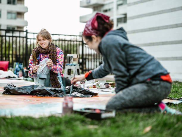 istock Two Young female artists creating outdoor mural 1428154410