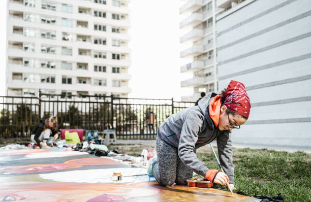 istock Two Young female artists creating outdoor mural 1428155133