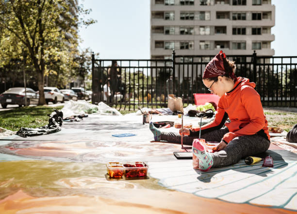 istock Young Latin woman creating outdoor mural 1428155138