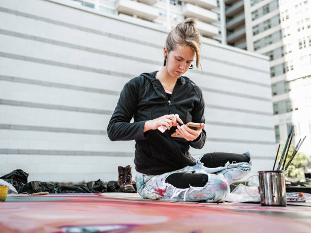 istock Young Caucasian woman creating outdoor mural 1428155154