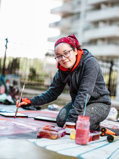 istock Young Latin woman creating outdoor mural 1428155160