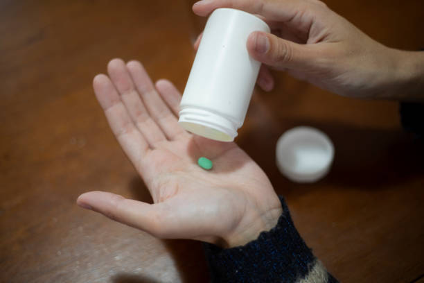 istock woman's hand with medicine 1428156566