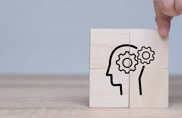 istock brain thinking, business brainstorm. Knowledge and ideas head icon on wooden cube. Transferring knowledge, innovation, brainstorming concept. Business strategies to technology. Business thinking. 1428156857