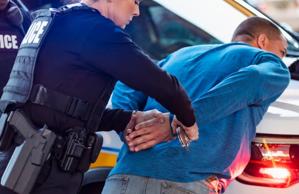 istock Policewoman and partner arresting man 1428169356