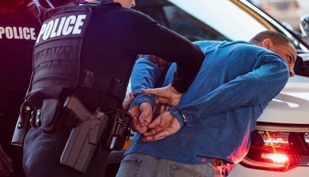 istock Policewoman and partner arresting man 1428169357