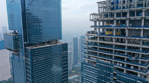 istock Skyscraper under construction, with crane on top, for urban and industrial themes 1428171036