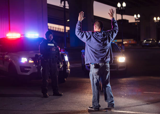 istock Suspect surrendering to police officer at night 1428171056