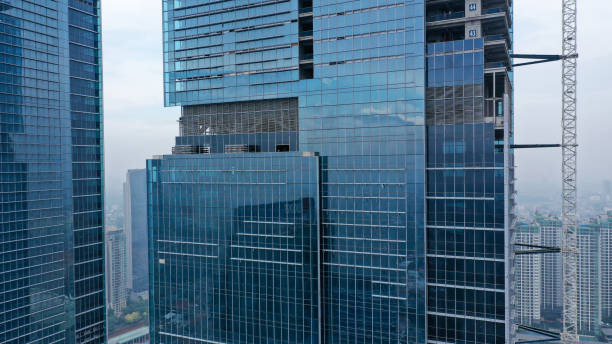 Skyscraper under construction, with crane on top, for urban and industrial themes