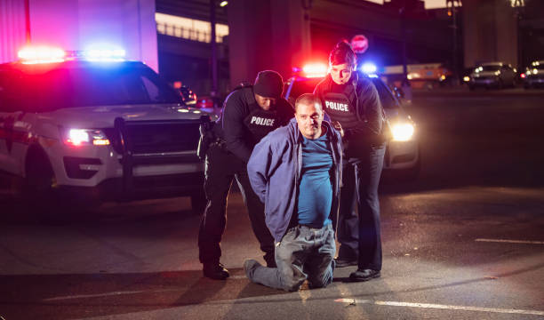 istock Two police officers arresting a suspect at night 1428171587