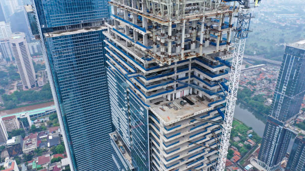 istock Skyscraper under construction, with crane on top, for urban and industrial themes 1428171596