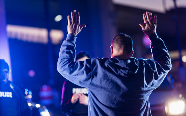 istock Man surrendering to police at night 1428171605