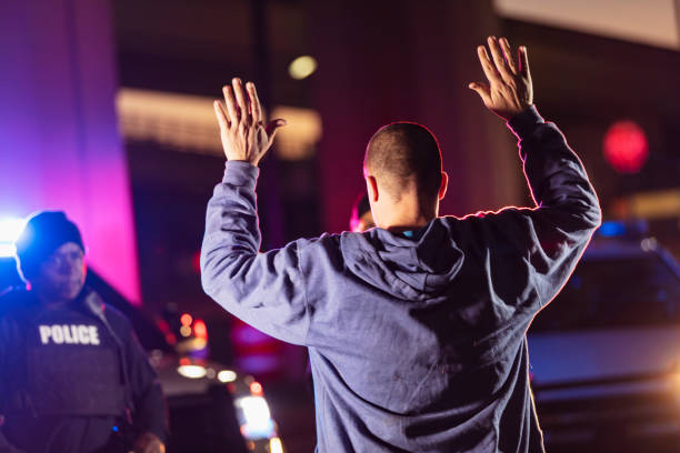 istock Man surrendering to police at night 1428171607