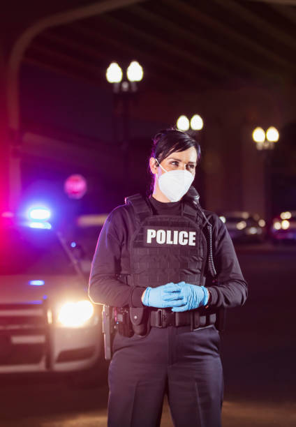 istock Policewoman working at night wearing n95 face mask 1428173265