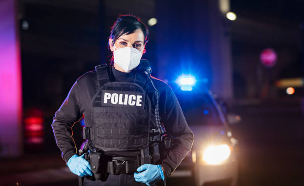 istock Policewoman working at night wearing n95 face mask 1428173814