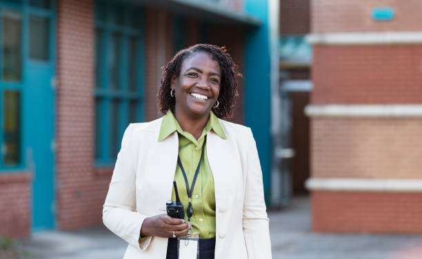 African-American teacher or principal outside school stock photo