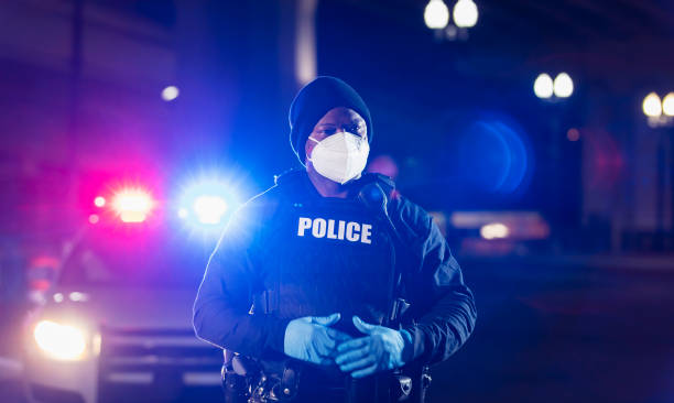 African-American police officer at night with face mask