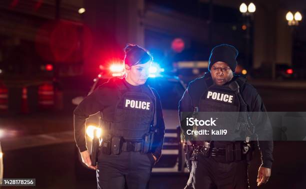Two police officers responding to call at night
