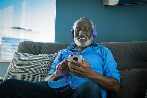 Elderly man listening to music at home