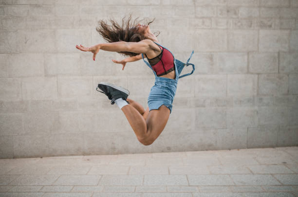 istock Fit female dancer performing a dance jump 1428187254