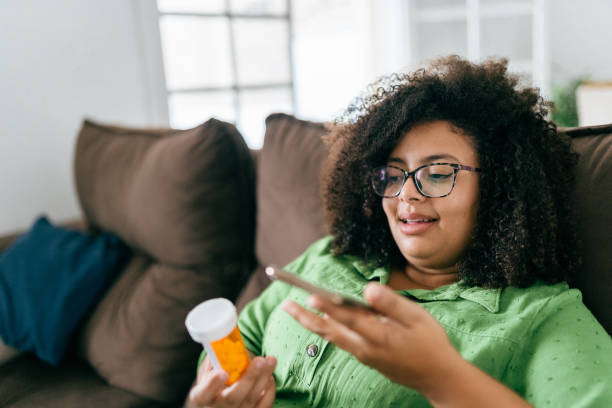 istock Woman checking medicine with smartphone 1428189699