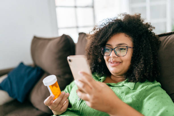 istock Woman checking medicine with smartphone 1428189711