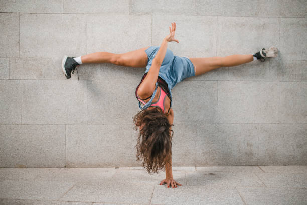 istock Sports woman does a handstand using one hand 1428190649