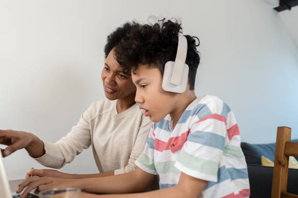istock Boy learning and his mother working online from their home office 1428191786