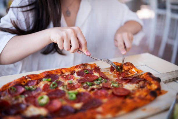 istock Woman eating unhealthy. 1428193493