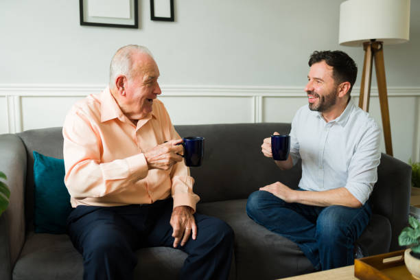 istock Excited elderly father and son chatting drinking coffee at home 1428204270