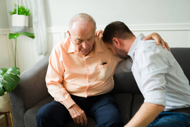 istock Depressed young man embracing his elderly senior father while crying 1428204280