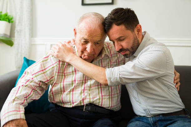 istock Caucasian son comforting and embracing his elderly old father 1428204525