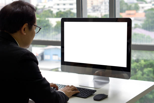 istock Asian senior manager in black suit sit at desk in office typing on computer keyboard with white screen display. 1428204544