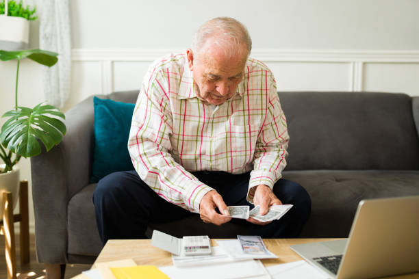 istock Smiling elderly man happy with his finances and pension 1428205101