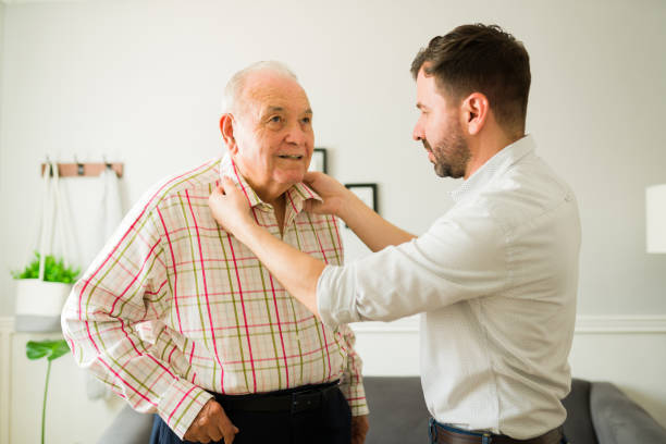 istock Smiling old man getting dressed to go out with his son 1428205167
