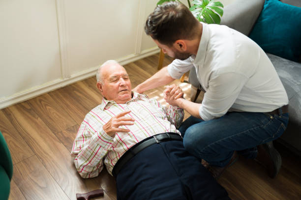 istock Pained elderly senior man suffering a fall and getting help to get up 1428205177