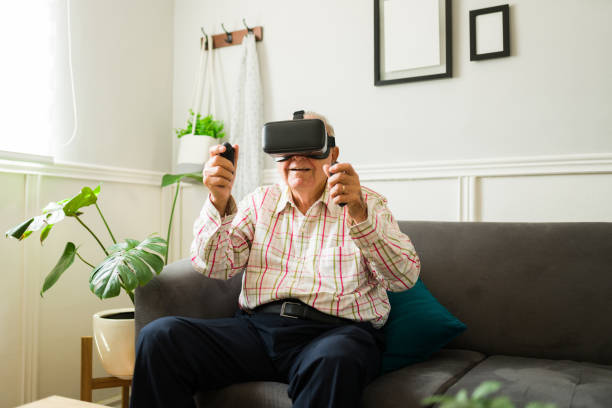 istock Excited senior man enjoying playing with virtual reality technology 1428205406