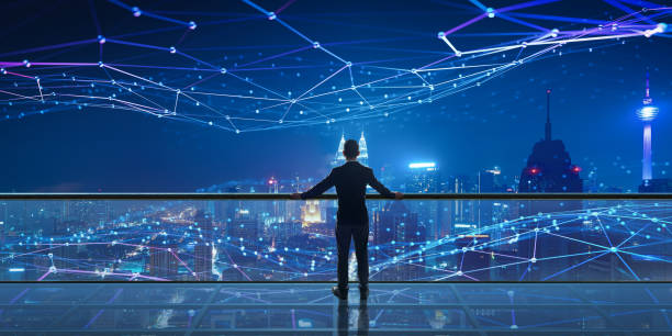 istock Businessman standing at office with night Smart city 1428207092