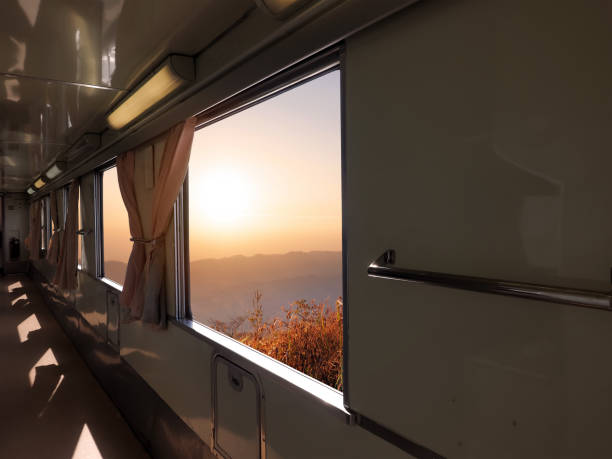 istock Walkway train interior with sunset mountain view outside. 1428208095