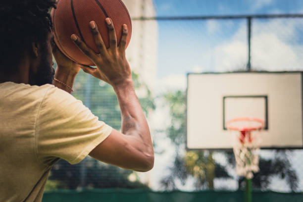 istock Hands on basketball making shot 1428212791