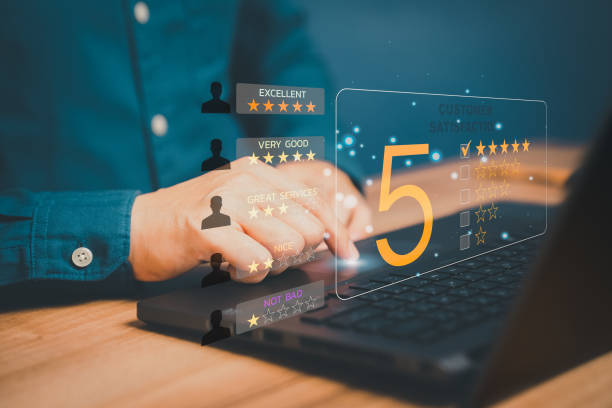 istock Man hand using computer laptop with popup five star icon for feedback review satisfaction service, Customer service experience and business satisfaction survey. 1428220900