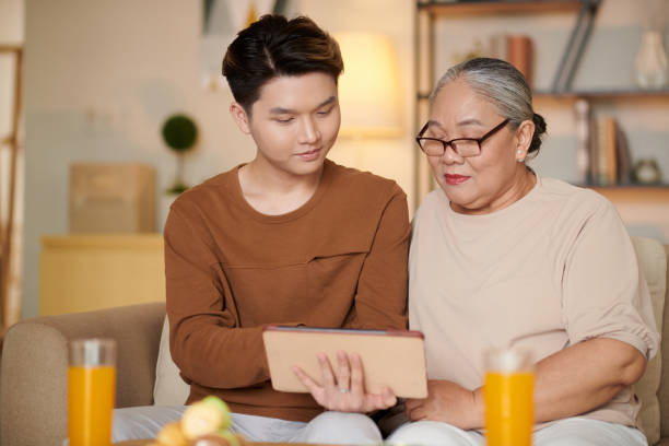 istock Grandmother and Son Using App on Tablet 1428223018