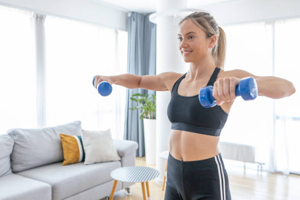 istock Female athlete doing strength workouts at home 1428225650