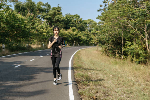 istock women exercise by running on the road. 1428226132