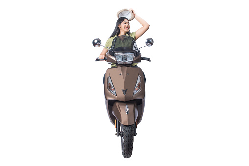 Asian woman sitting on a scooter and taking off hat isolated over white background