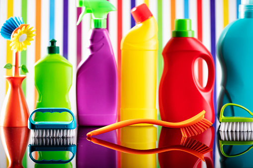 Colorful cleaning kit on background in the form of colorful stripes.