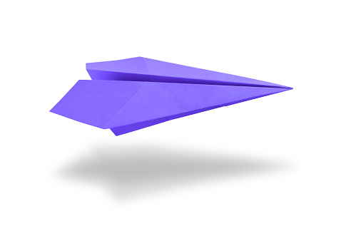 Purple paper plane origami isolated on a blank white background