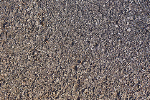 old asphalt in the cracks in the sun. Background, texture, copy space