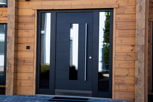Modern black front door on a new wooden house