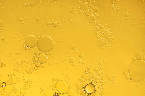 istock Golden yellow abstract oil bubbles or face serum background. 1428233567